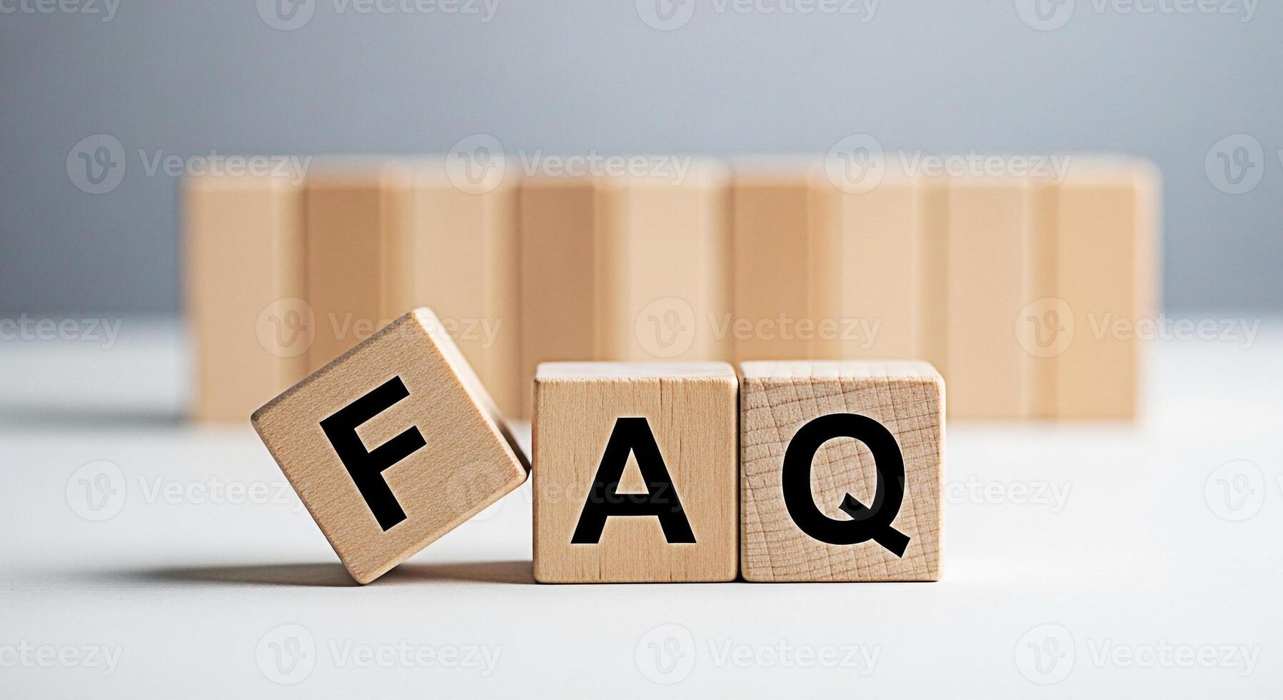 Wooden blocks spelling FAQ on a white surface representing frequently asked questions and information creating a clear and helpful atmosphere for customer service and support resources photo