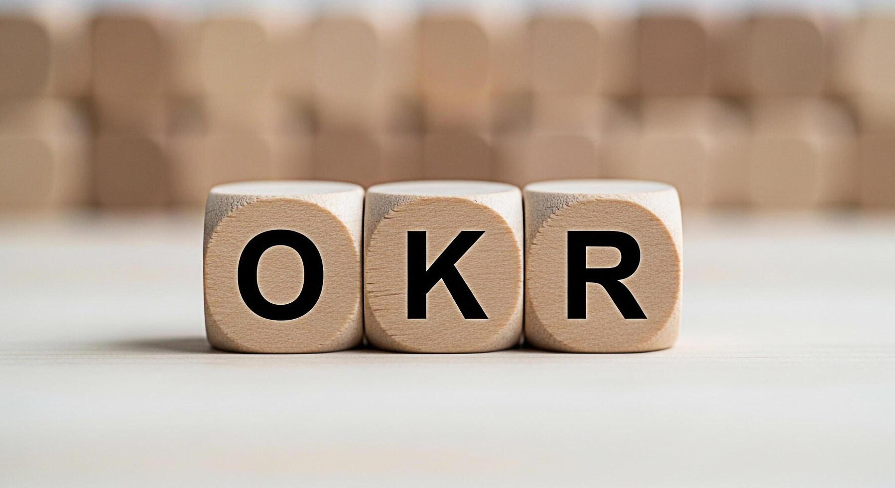 Wooden blocks displaying OKR acronym on a bright surface symbolizing Objectives and Key Results a strategic framework for goal setting and performance management in business and organizational success photo