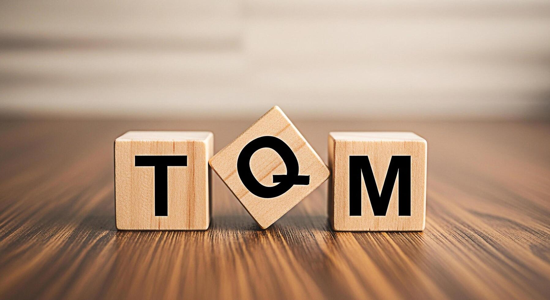 Wooden blocks displaying TQM on a wooden surface representing total quality management in a business setting symbolizing efficiency and continuous improvement for organizational success photo