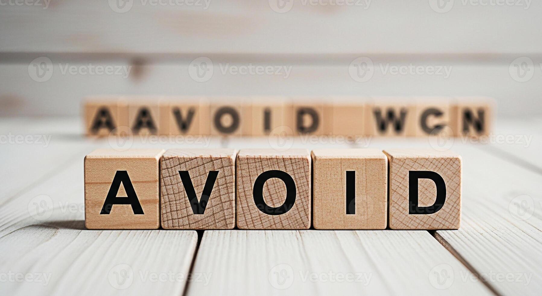 Wooden blocks spelling AVOID on a white wooden surface symbolizing prevention and caution creating a sense of awareness and control in a bright clean environment photo