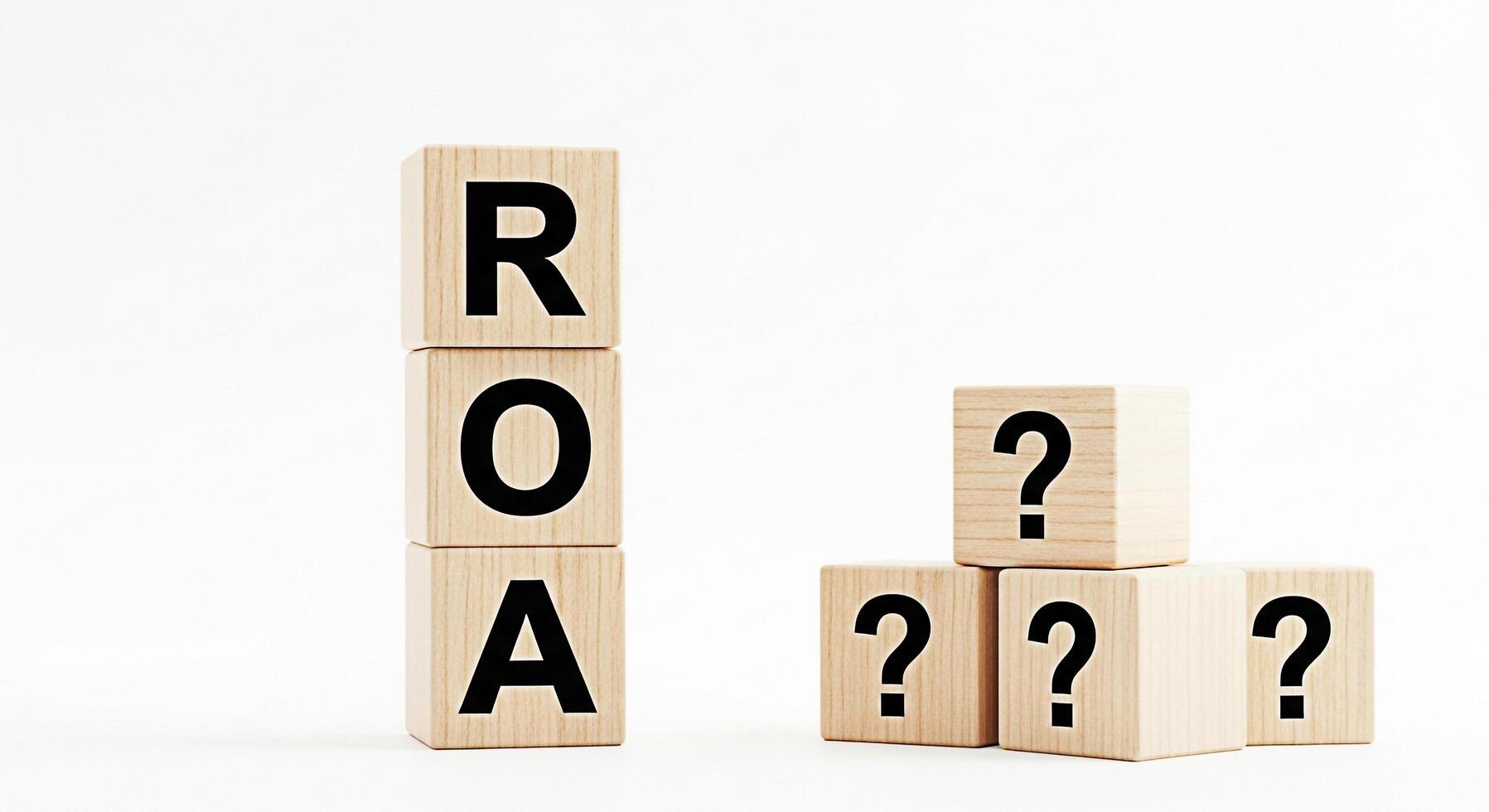 Wooden blocks displaying ROA and question marks on a white background representing the concept of Return on Assets financial uncertainty and business investment decisions in a minimalist setting photo
