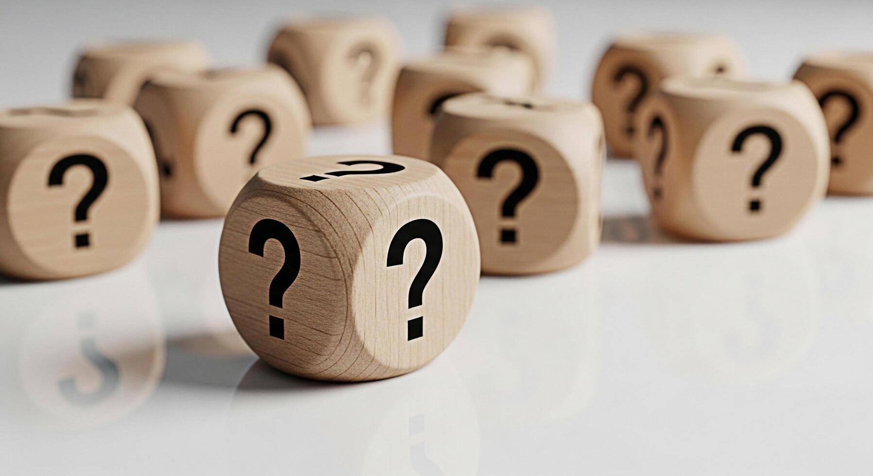 Wooden dice displaying question marks on a white reflective surface symbolizing uncertainty and the search for answers in a clean and minimalist setting creating a sense of curiosity and intellectual photo