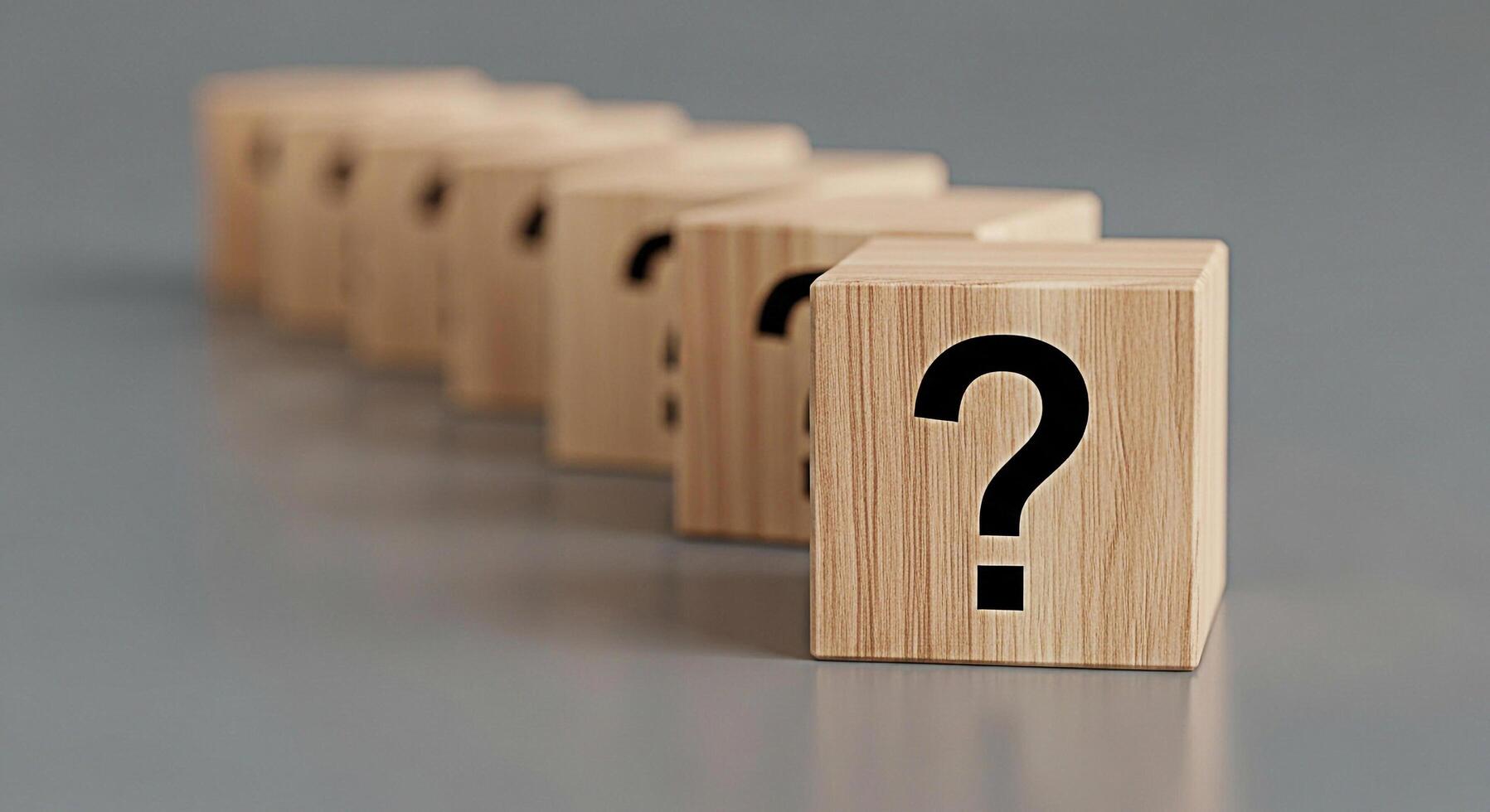 Row of wooden blocks displaying question marks on a gray surface symbolizing uncertainty and the need for solutions in a complex business environment evoking curiosity and problemsolving photo