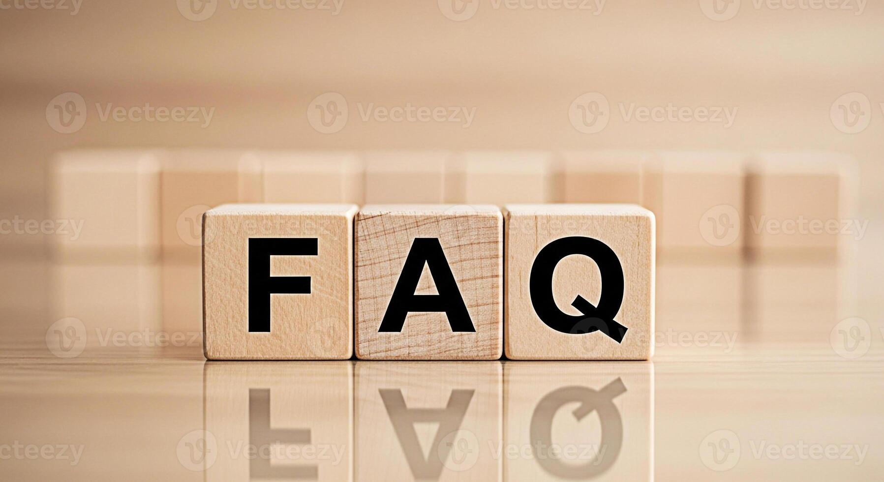 FAQ wooden blocks displaying information on a reflective surface representing frequently asked questions and providing clarity in a simple and accessible manner promoting understanding and guidance photo