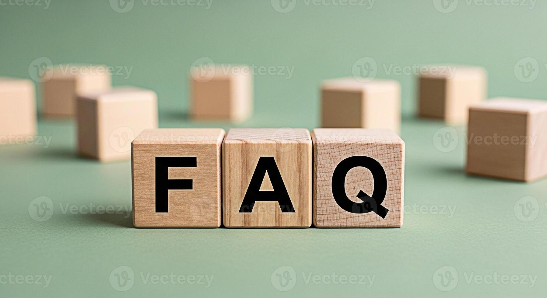 Wooden blocks displaying FAQ on a green surface representing frequently asked questions and information resources in a simple clear and accessible manner promoting knowledge and assistance photo