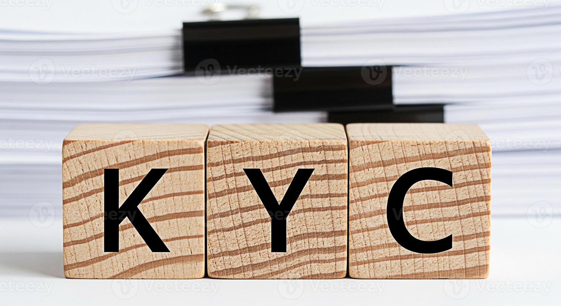 Wooden blocks spelling KYC in a bright office setting representing the concept of regulatory compliance and identity verification for financial institutions and customer due diligence processes photo