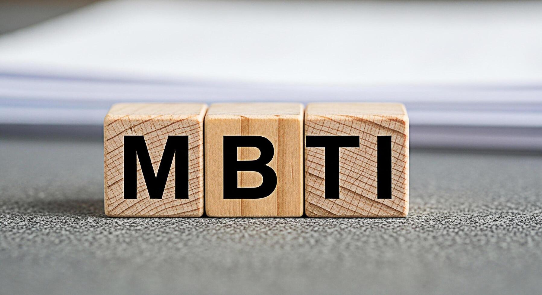 Wooden blocks displaying MBTI on a textured surface representing personality assessment and psychological types fostering selfawareness and understanding in a professional or educational setting photo