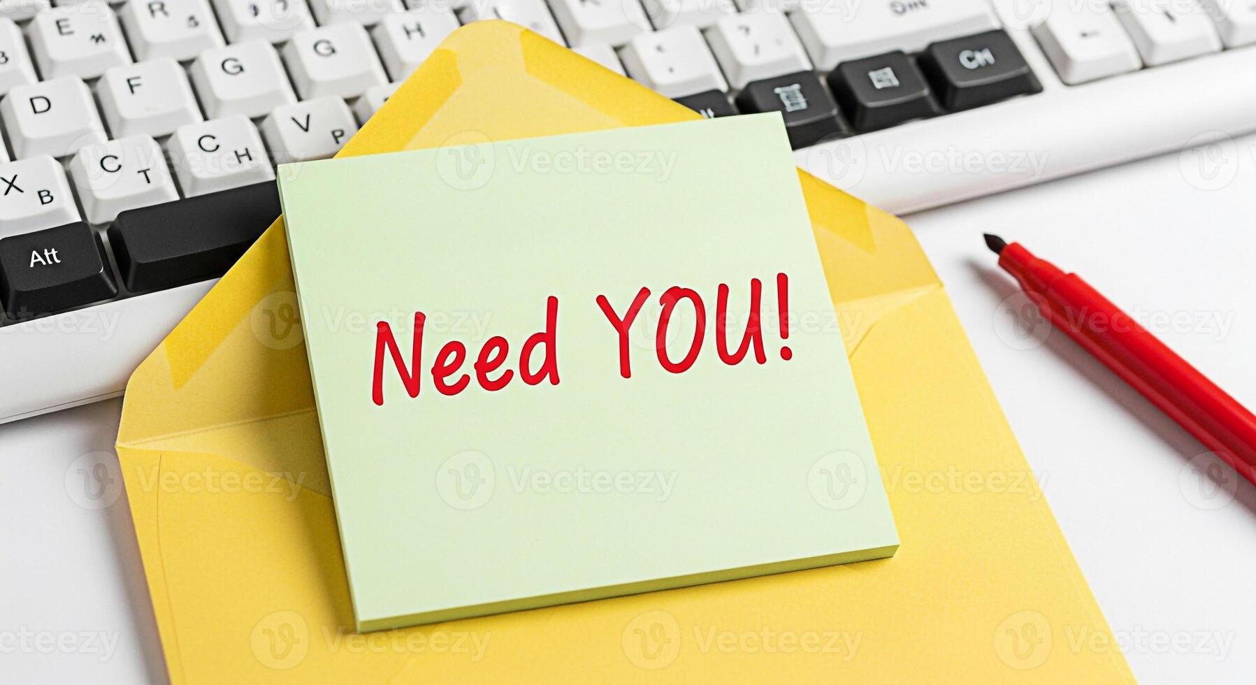 Urgent message on a sticky note Need YOU placed on a yellow envelope near a computer keyboard and red marker conveying a sense of importance and immediate requirement in a modern office setting photo