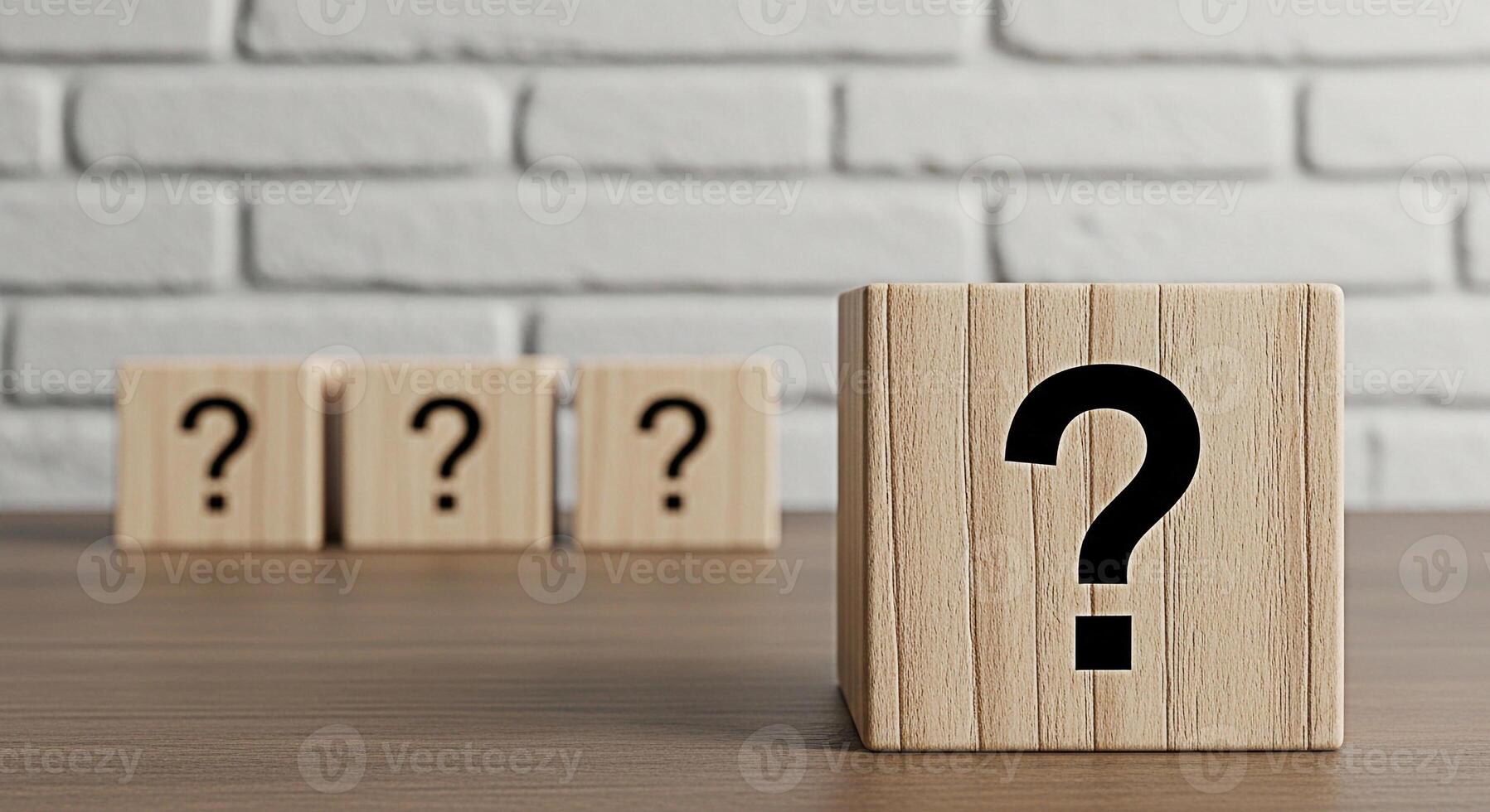 Wooden blocks displaying question marks on a wooden table against a white brick wall representing uncertainty inquiry and the search for answers in a clean and minimalist setting photo