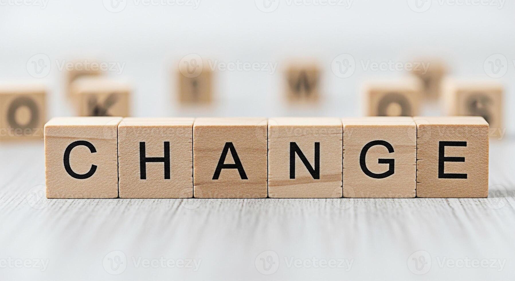 Wooden blocks spelling CHANGE on a gray surface symbolizing transformation and progress in a bright minimalist setting representing opportunity and the potential for positive development photo