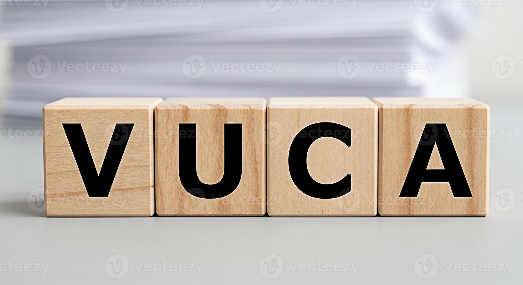 Wooden blocks spelling VUCA on a gray surface representing volatility uncertainty complexity and ambiguity in a business environment conveying a sense of challenge and strategic planning photo