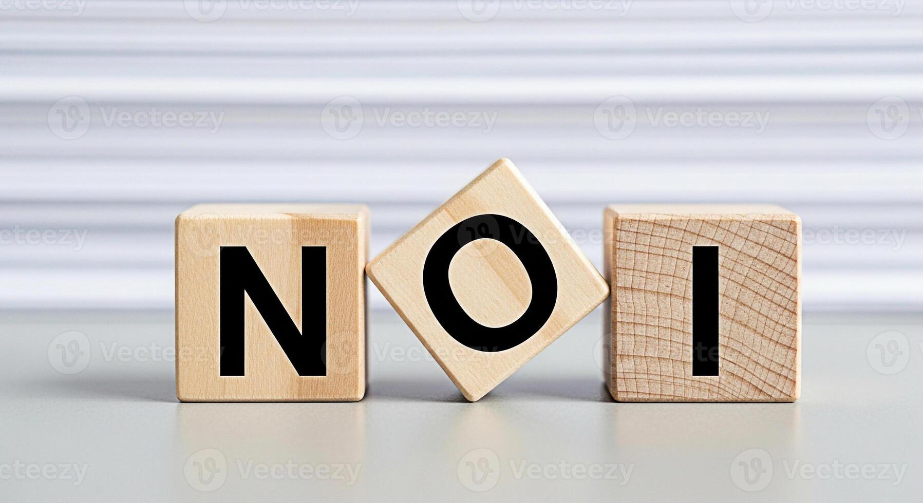 Wooden blocks spelling NOI on a gray surface conveying a message of decision and choice in a clean minimalist setting creating a sense of clarity and directness suitable for business or personal devel photo