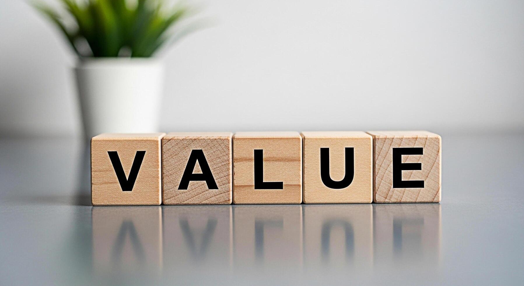 Wooden blocks spelling VALUE on a gray surface in a bright studio symbolizing importance worth and fundamental principles conveying a message of significance and core beliefs photo
