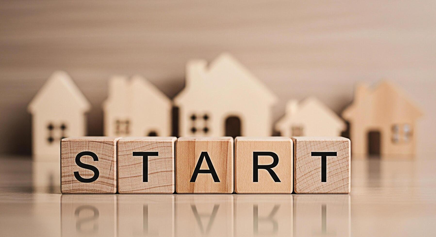 Wooden blocks spelling START in front of miniature house models symbolizing the beginning of a homeownership journey creating a hopeful and optimistic atmosphere for potential buyers and real estate i photo
