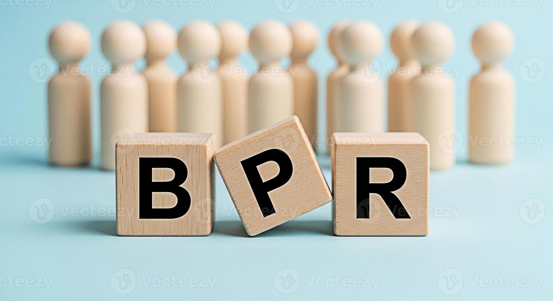 Wooden figures representing a team standing behind wooden blocks spelling BPR on a blue surface symbolizing business process reengineering and organizational change for improved efficiency and success photo