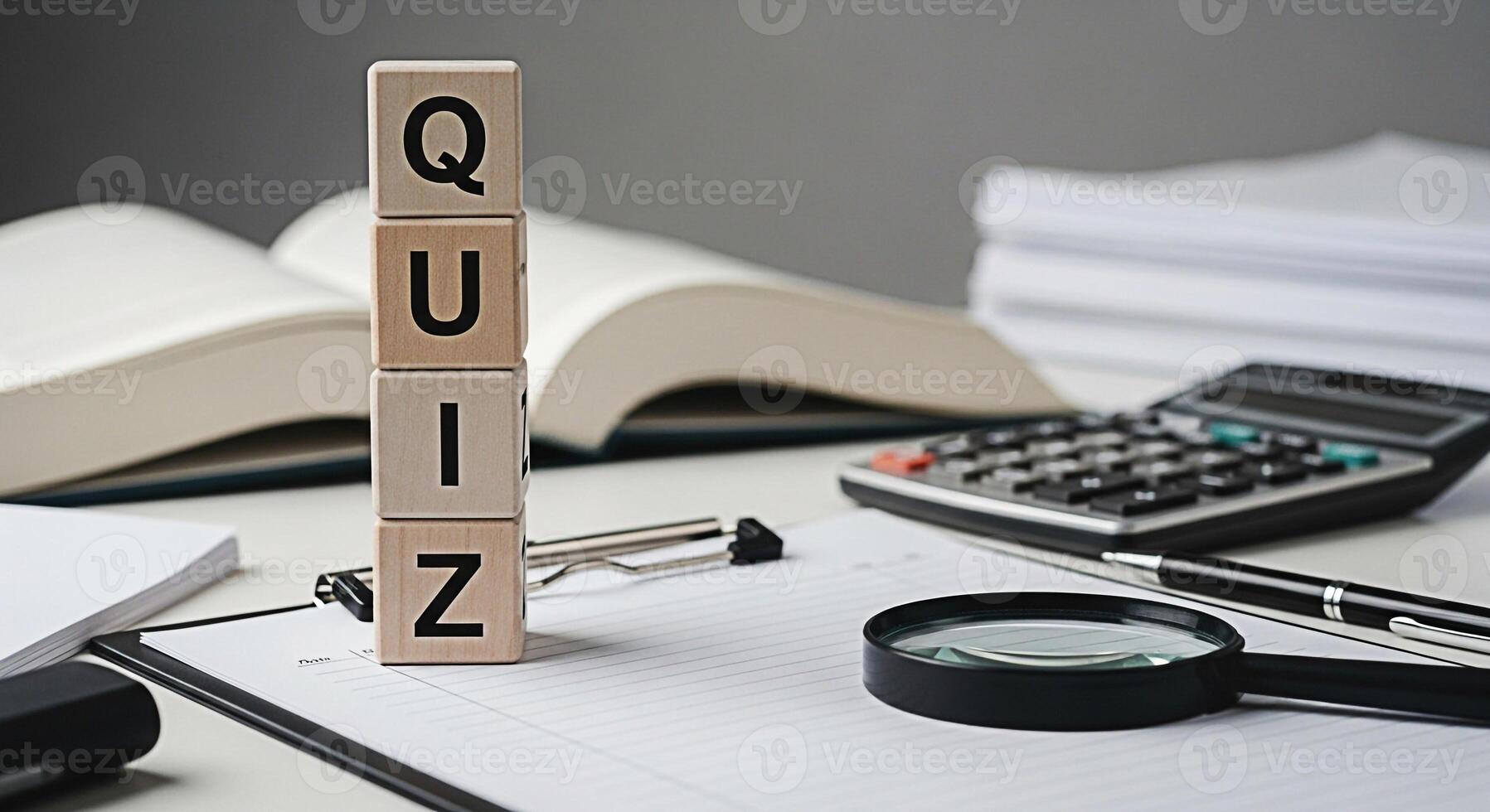 Wooden blocks spelling QUIZ sit on a desk with a magnifying glass calculator and open books representing education learning and the challenge of testing knowledge in a bright academic setting photo