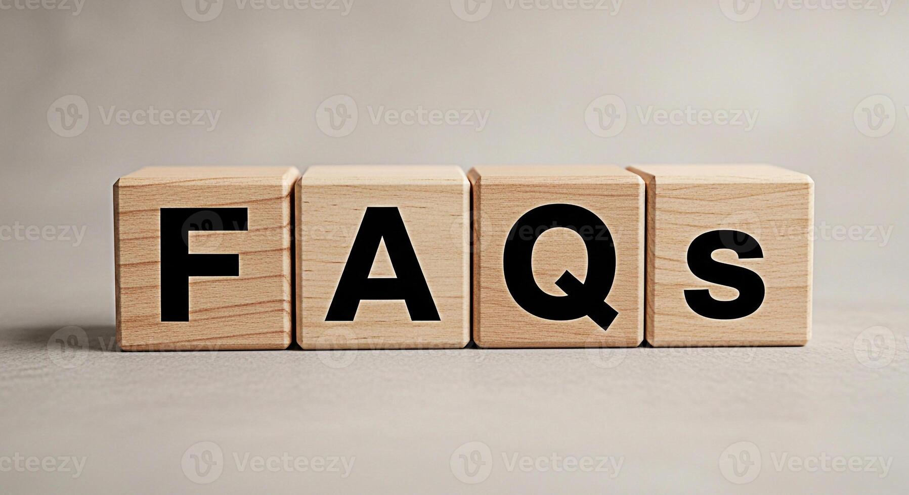 Wooden blocks displaying FAQs on a neutral surface representing information and customer support creating a clear and accessible resource for answering common questions and providing assistance photo