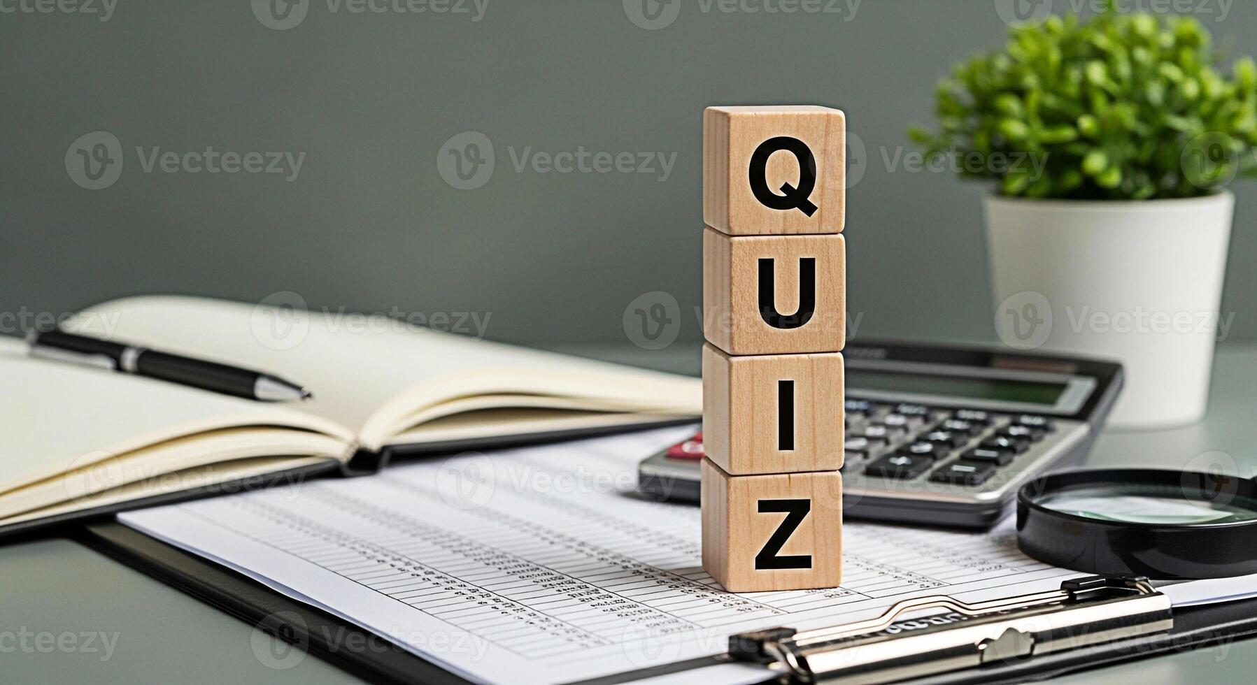 Wooden blocks spelling QUIZ on a desk with a calculator notebook and magnifying glass representing knowledge assessment and the challenge of answering questions in an educational environment photo