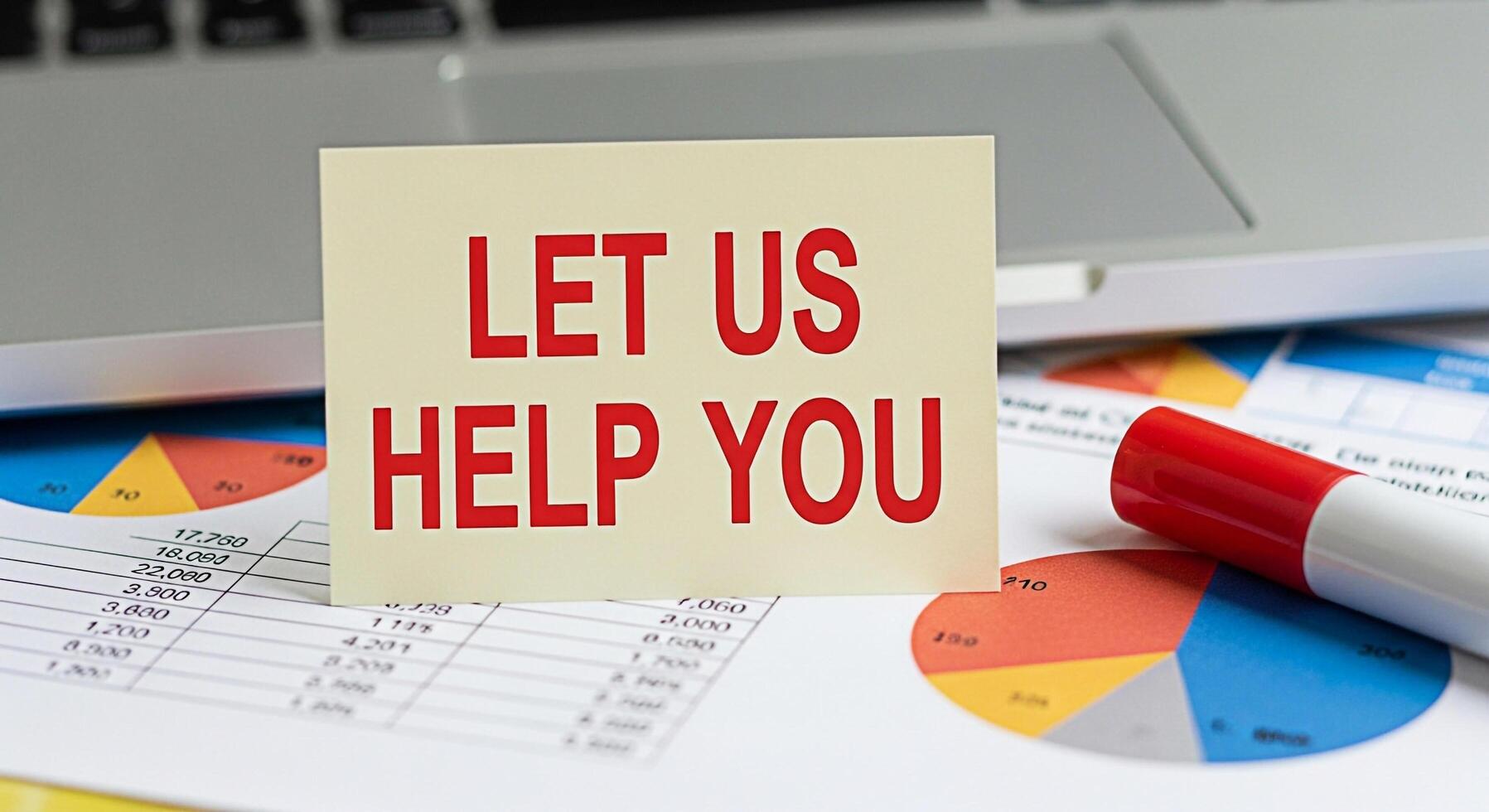 Supportive business concept with a card reading Let Us Help You placed on financial charts and a laptop suggesting assistance and problemsolving in a professional and collaborative environment photo