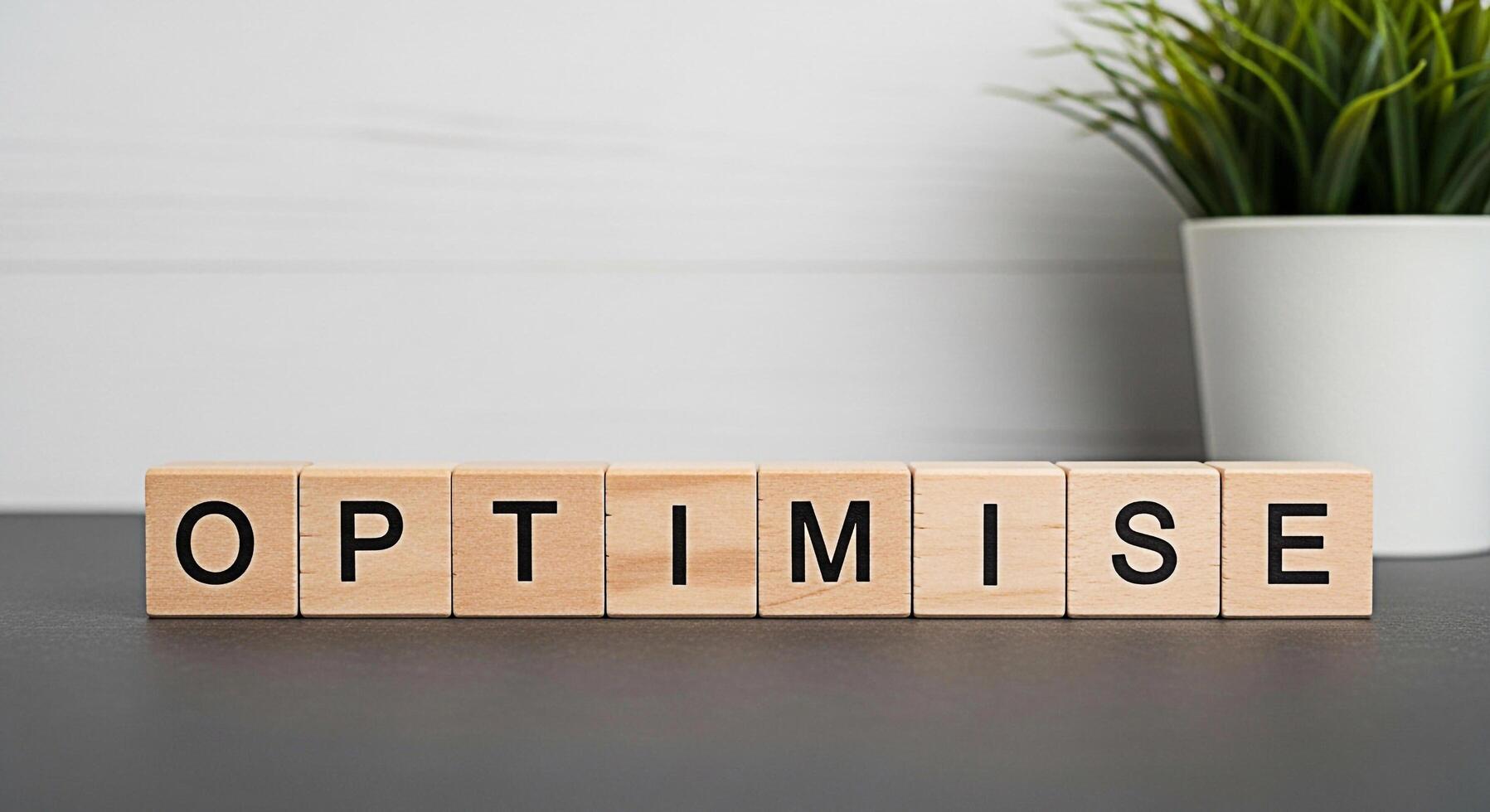 Wooden blocks spelling OPTIMISE on a gray surface in a bright room symbolizing business optimization efficiency and the importance of refining processes for success and growth in a modern business env photo