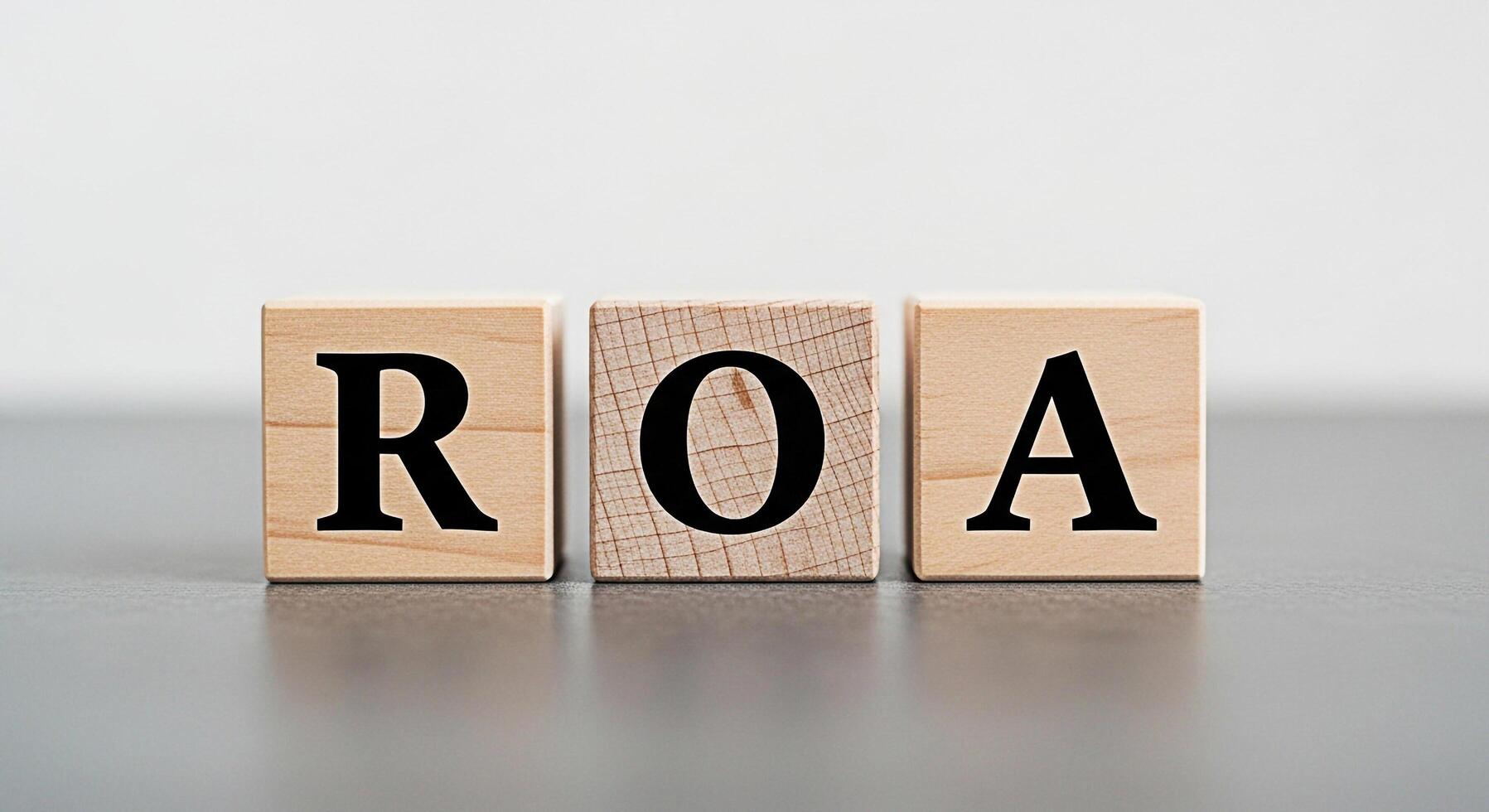 Wooden blocks displaying ROA on a gray surface representing Return on Assets a key financial metric for evaluating a companys profitability and efficiency in asset utilization conveying a sense of fin photo
