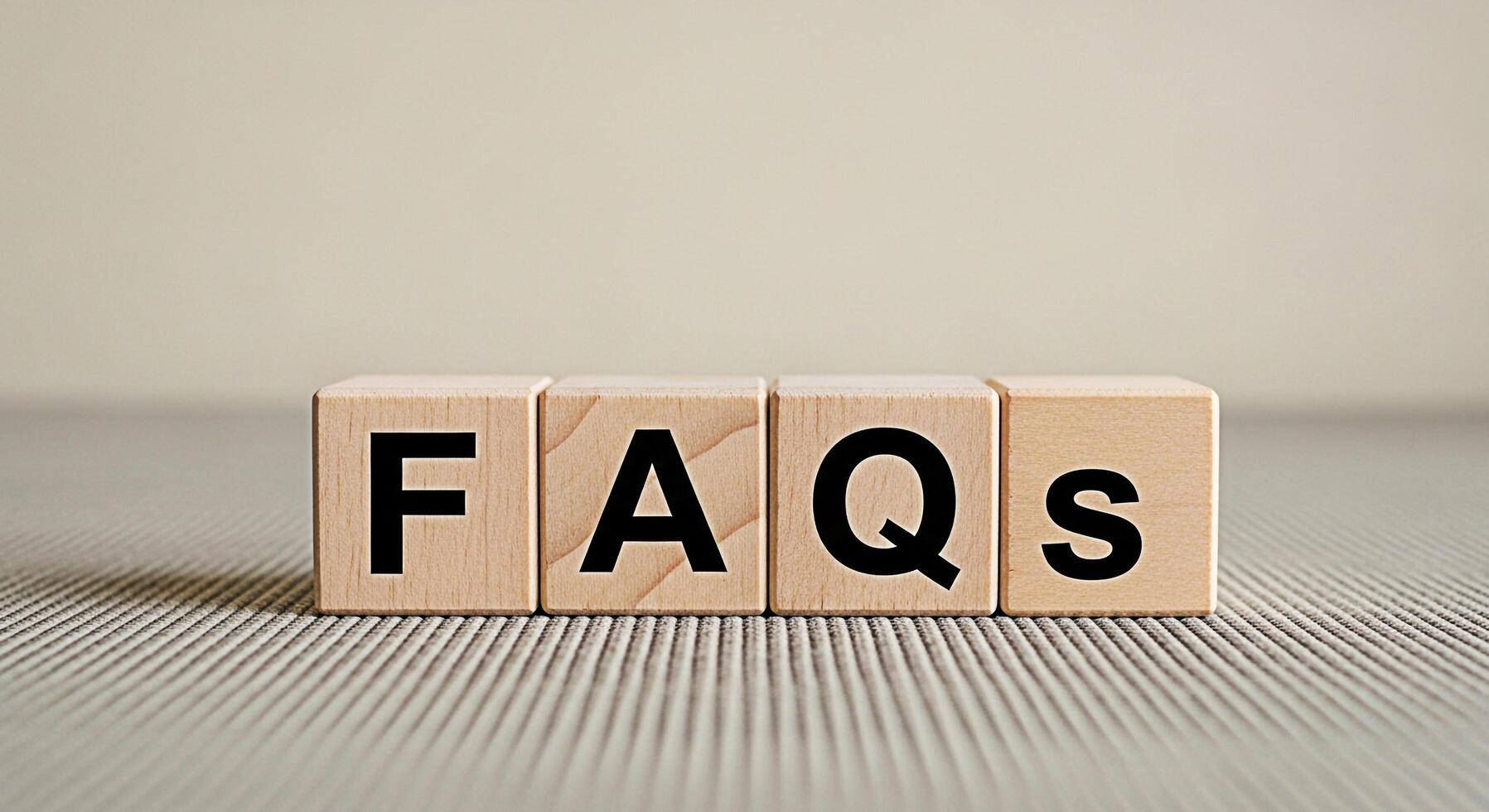 Wooden blocks displaying FAQs on a textured surface representing information access and customer support in a simple clear and accessible manner emphasizing knowledge and problemsolving photo