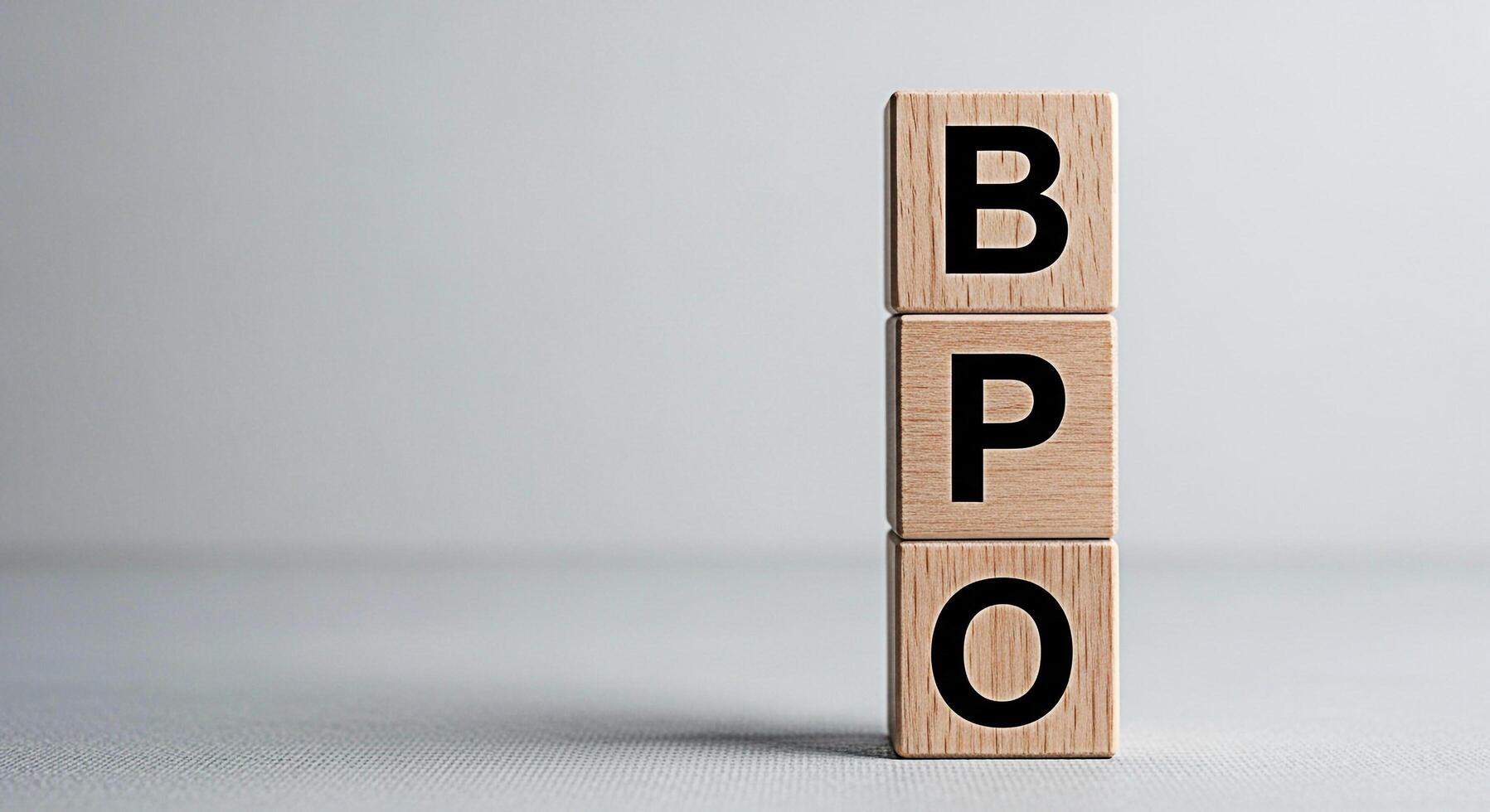Wooden blocks displaying BPO in a minimalist studio setting symbolizing business process outsourcing and efficient operational strategies for global business expansion and growth in a competitive mark photo