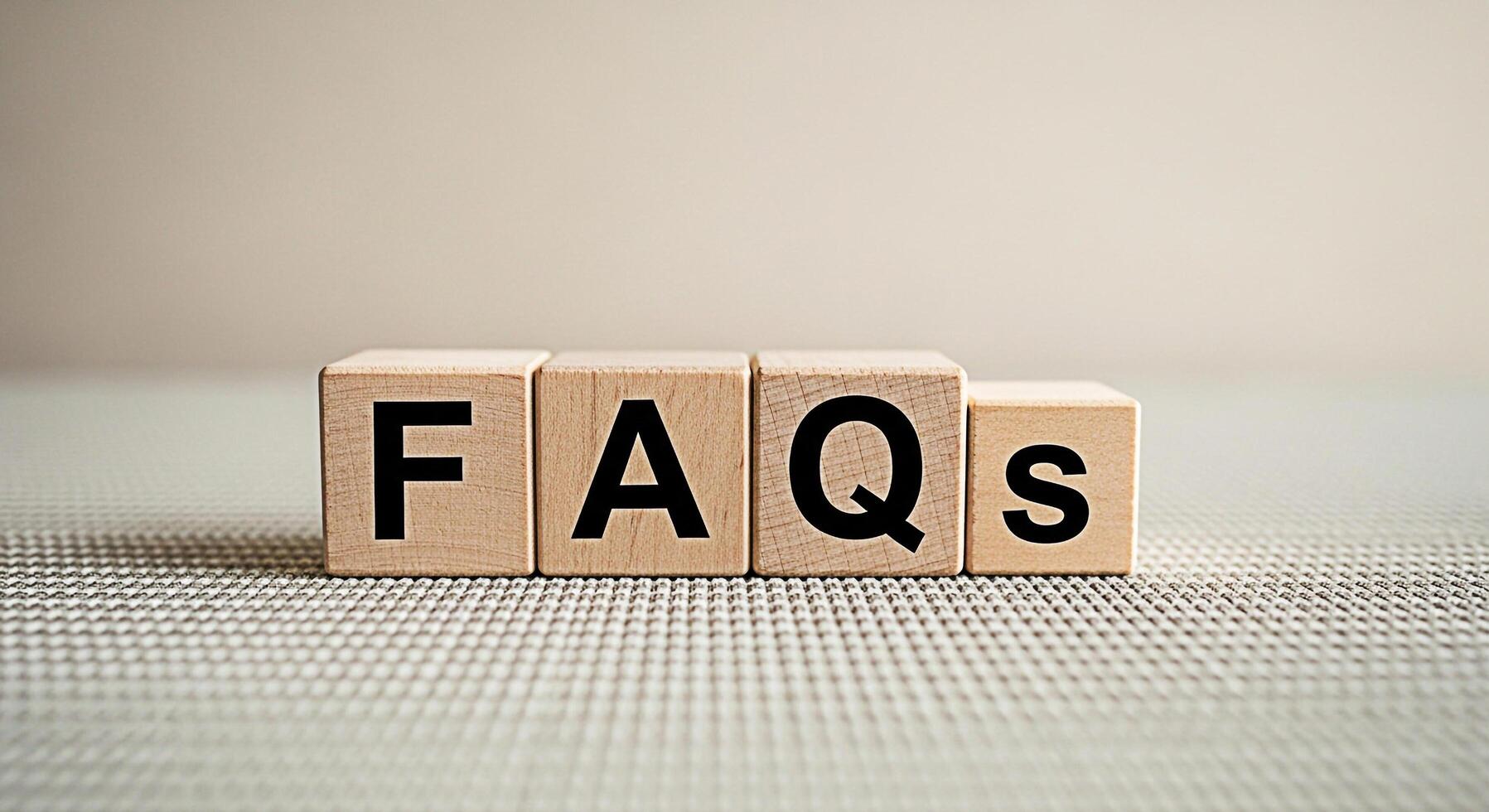 Wooden blocks displaying FAQs on a textured surface representing frequently asked questions in a simple and informative way ideal for websites presentations and educational materials conveying clarity photo