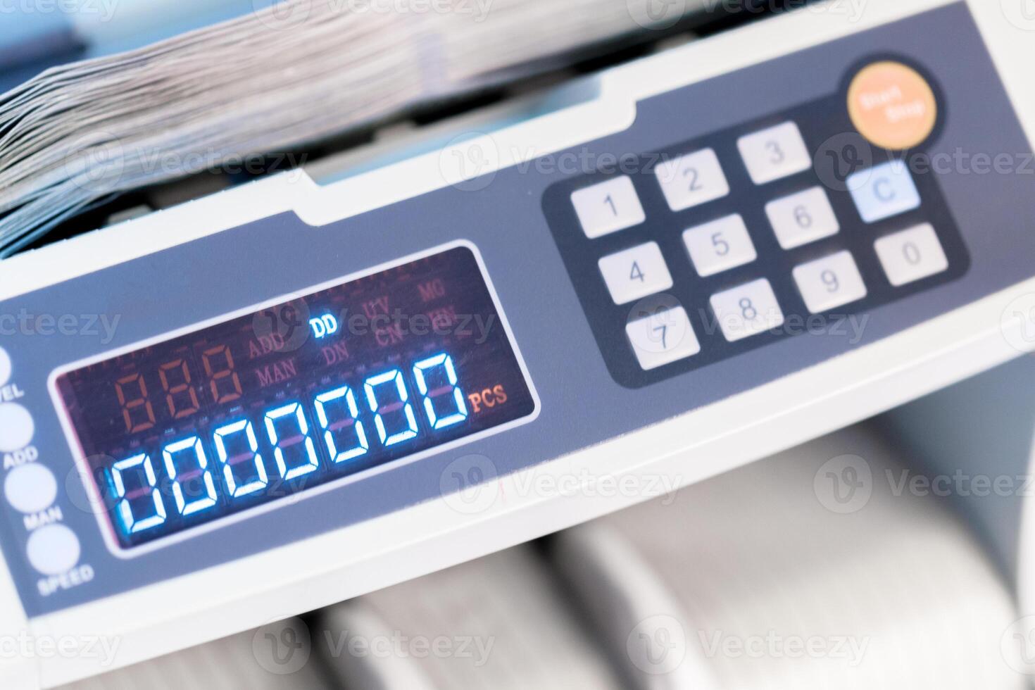 Counting machine displays numbers while sorting papers in an office setting photo