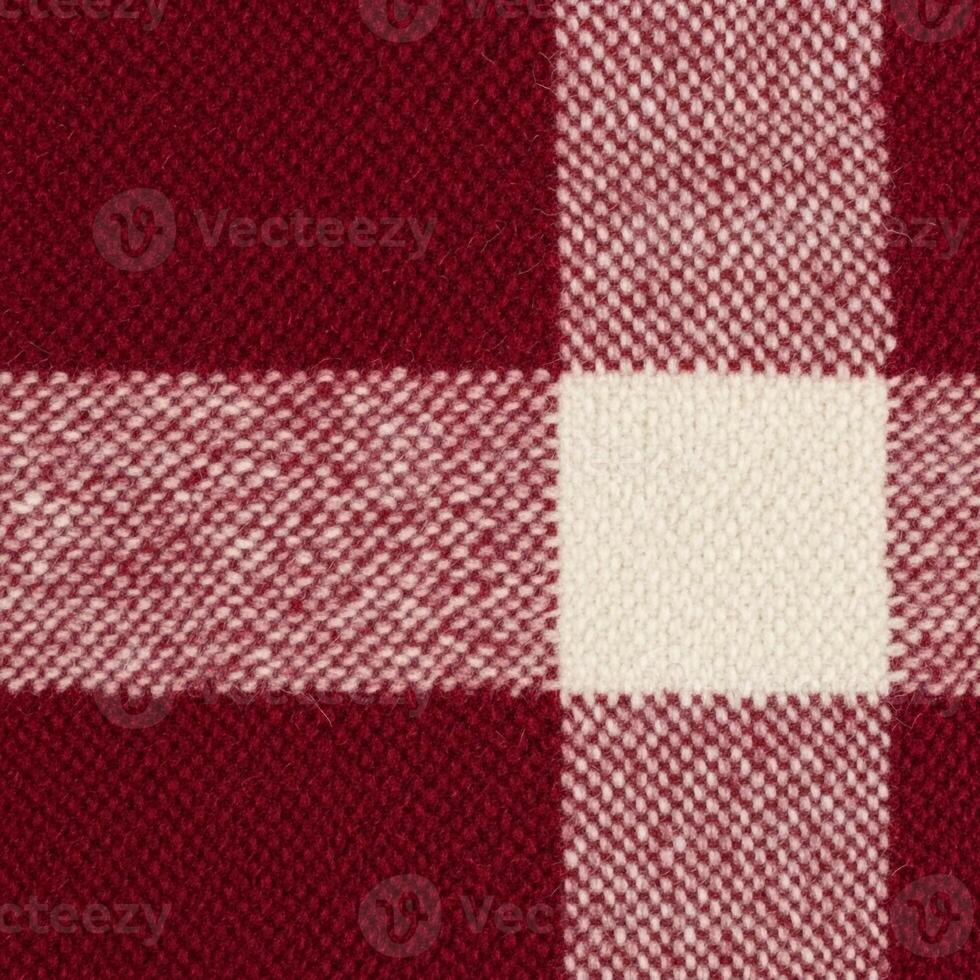 Close up view of a rustic buffalo plaid fabric pattern in deep red and cream colors photo