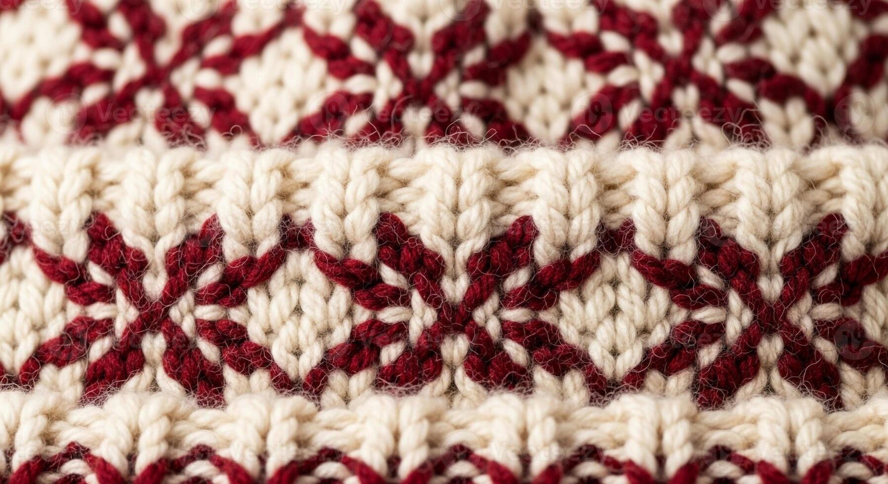 Close up of a traditional knitted fabric featuring a repeating geometric snowflake pattern in cream and deep red colors photo