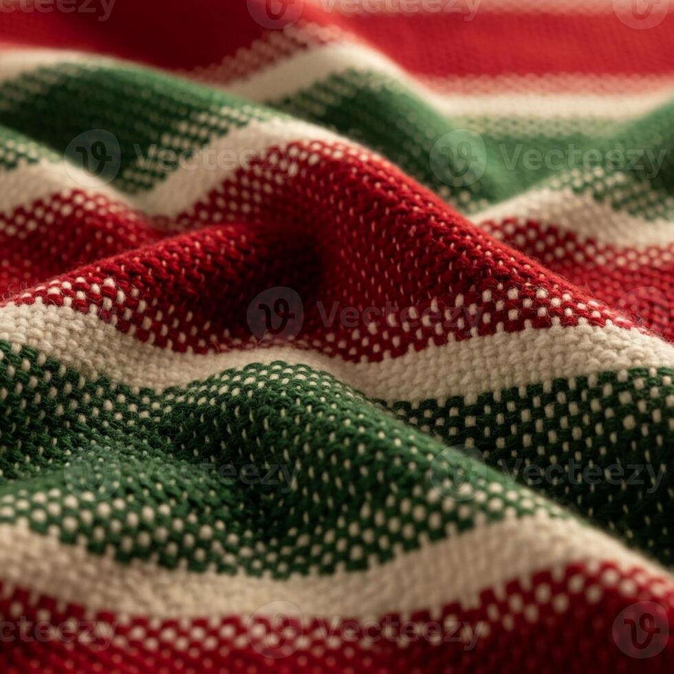 Close up view of a textured woven fabric with alternating red white and green stripes creating a festive holiday pattern photo