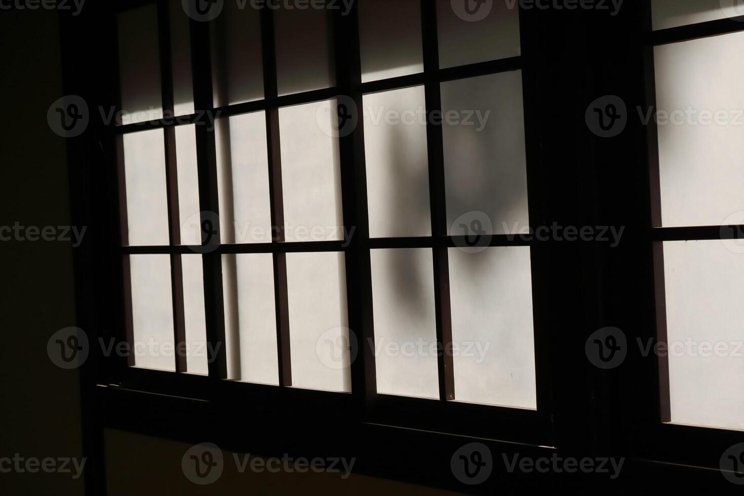 Dramatic Backlit Window Grid Silhouette Creating Geometric Pattern photo