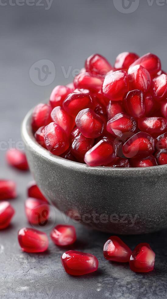 Fresh pomegranate seeds in bowl create vibrant display of health and food. Their juicy texture and rich color make them delightful addition to any dish photo