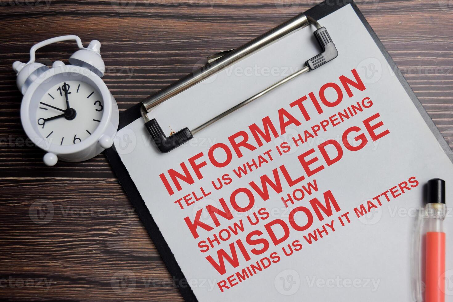 Concept of information tell us what is happening, knowledge show us how, wisdom reminds us why it matters write on clipboard isolated on Wooden Table. photo
