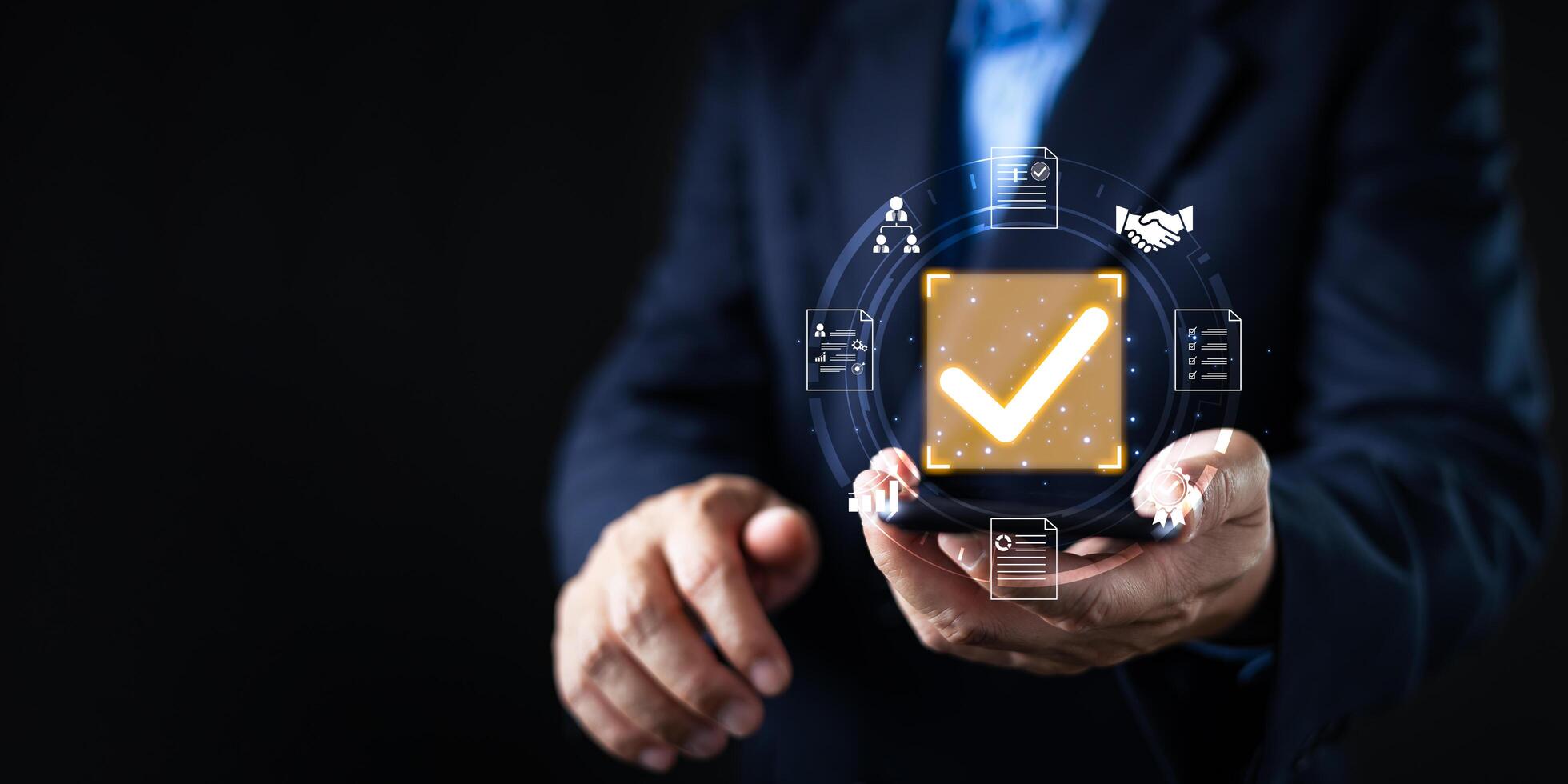 A businessman holds a glowing digital checkmark icon surrounded by document, approval, and partnership symbols, representing verified digital processes, compliance, and secure business operations. photo