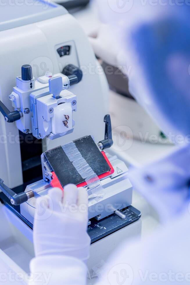 Scientist conducting precise material slicing in a laboratory setting during daytime photo