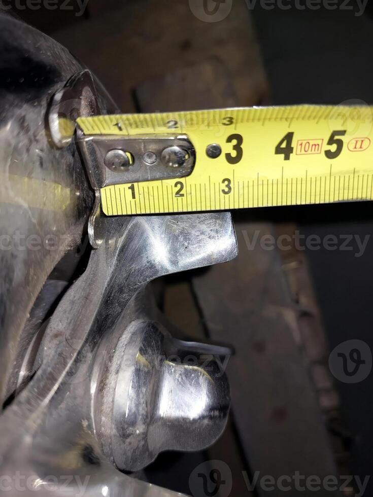 A close up of a metal object with a measuring tape photo