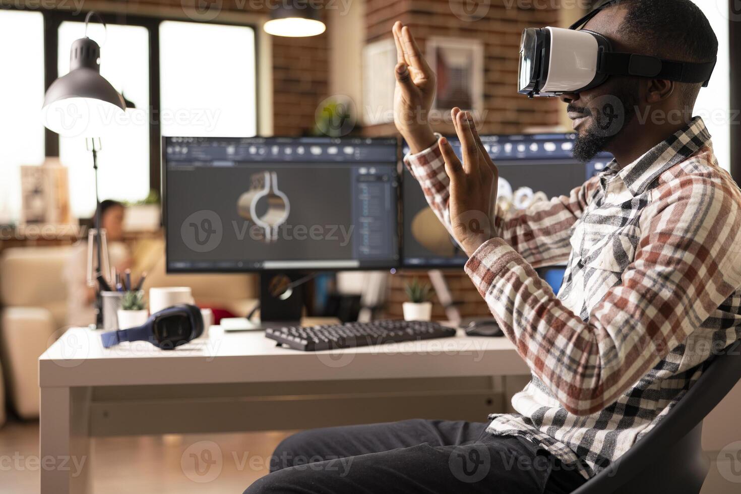 Focused black designer using virtual reality headset to develop digital building models for construction projects. Advanced immersive technology supporting interactive design review. photo
