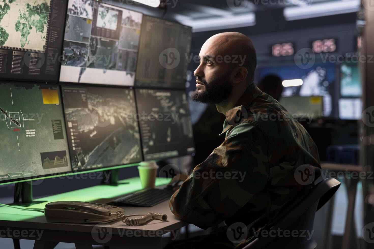 Military early warning systems operator in command center monitoring incoming enemy aerial attacks. Middle Eastern army agent maintains air space superiority with radar during armed conflict photo