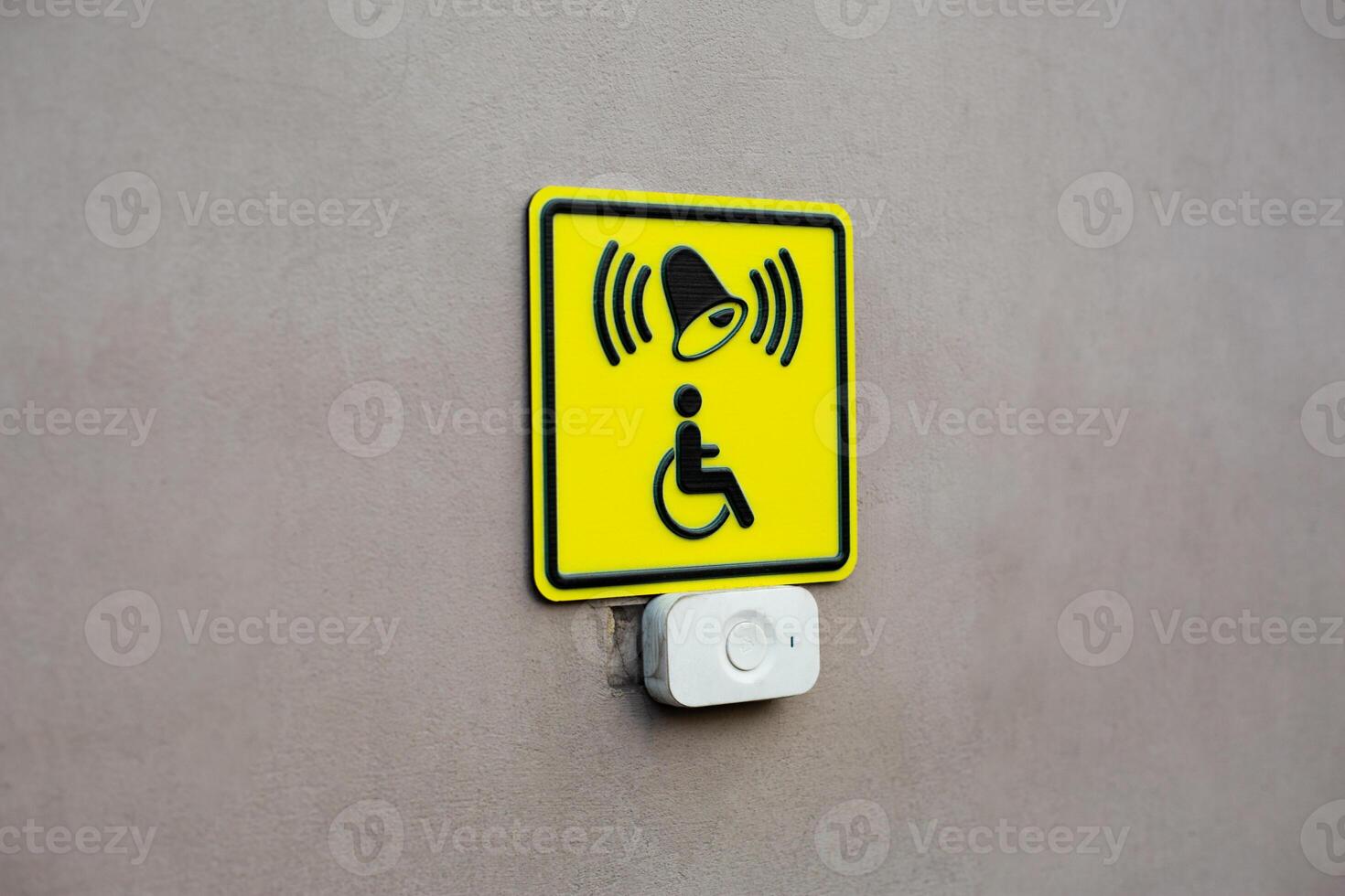 Plain wall with disabled sign and call button. News about creating accessible environment for people with disabilities. Concept for helping people. Take care of persons photo