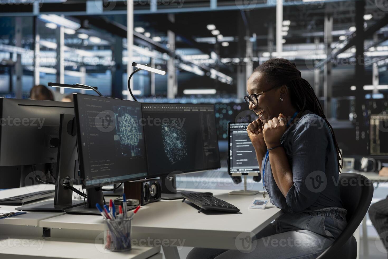 Excited engineer in data center celebrating successful AI implementation. Smiling server hub employee excited after artificial intelligence model completes training process with optimal results photo