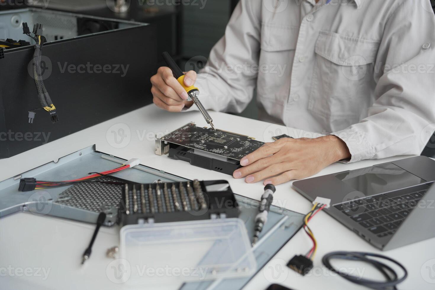 Closeup hand of computer hardware technician dissemble and fixing computer PC photo