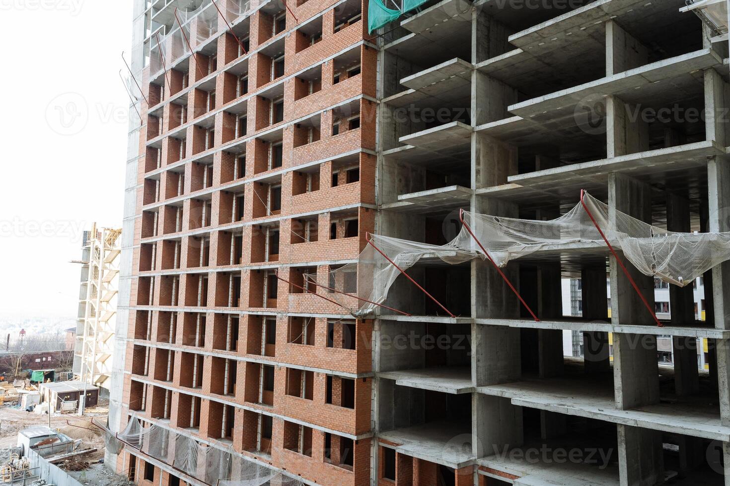 building process with visible materials, unfinished structure showcasing concrete and brick elements, scene of developing industrial building with exposed concrete and brick surfaces in progress photo