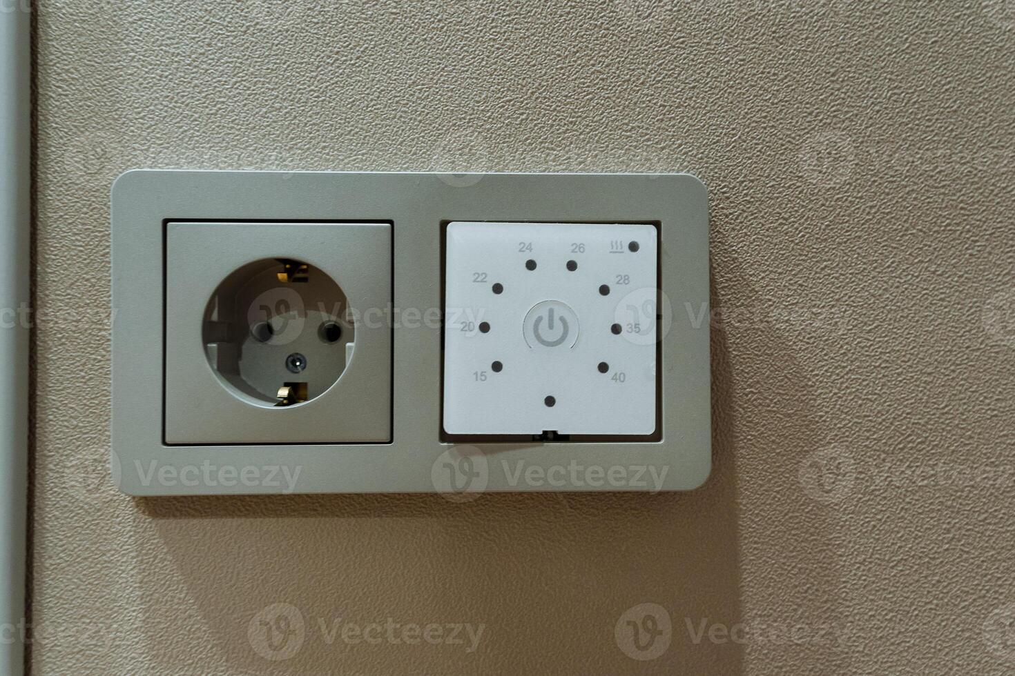 electrical setup preview, wall socket with mounting details, closeup of electrical panel and mounting holes, beige wall feature with exposed metal connector pattern ready for switch photo