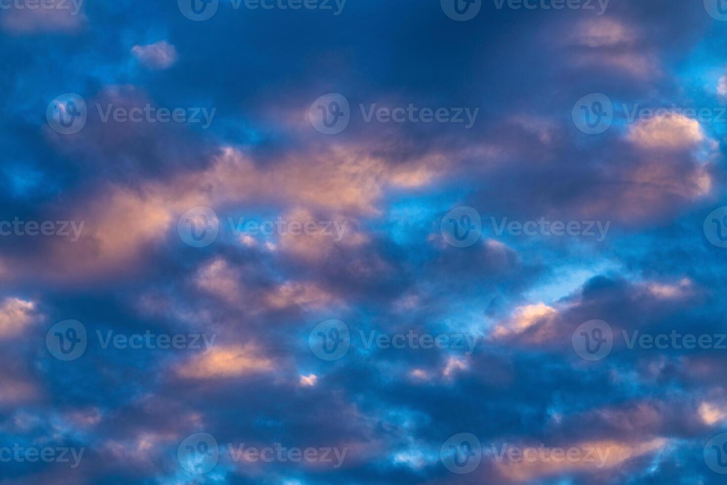 Amazing clouds in blue sky, illuminated by rays of sun at sunset to change weather. Colorful abstract cloudscape background photo