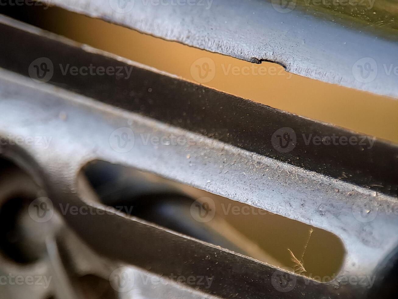 An abstract image showing a weathered metal structure with geometric openings and textures. photo
