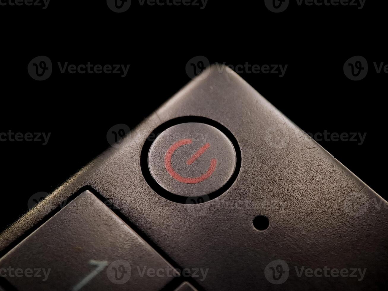 Textured surface shows an power symbol button, hinting at control and technological operation. photo
