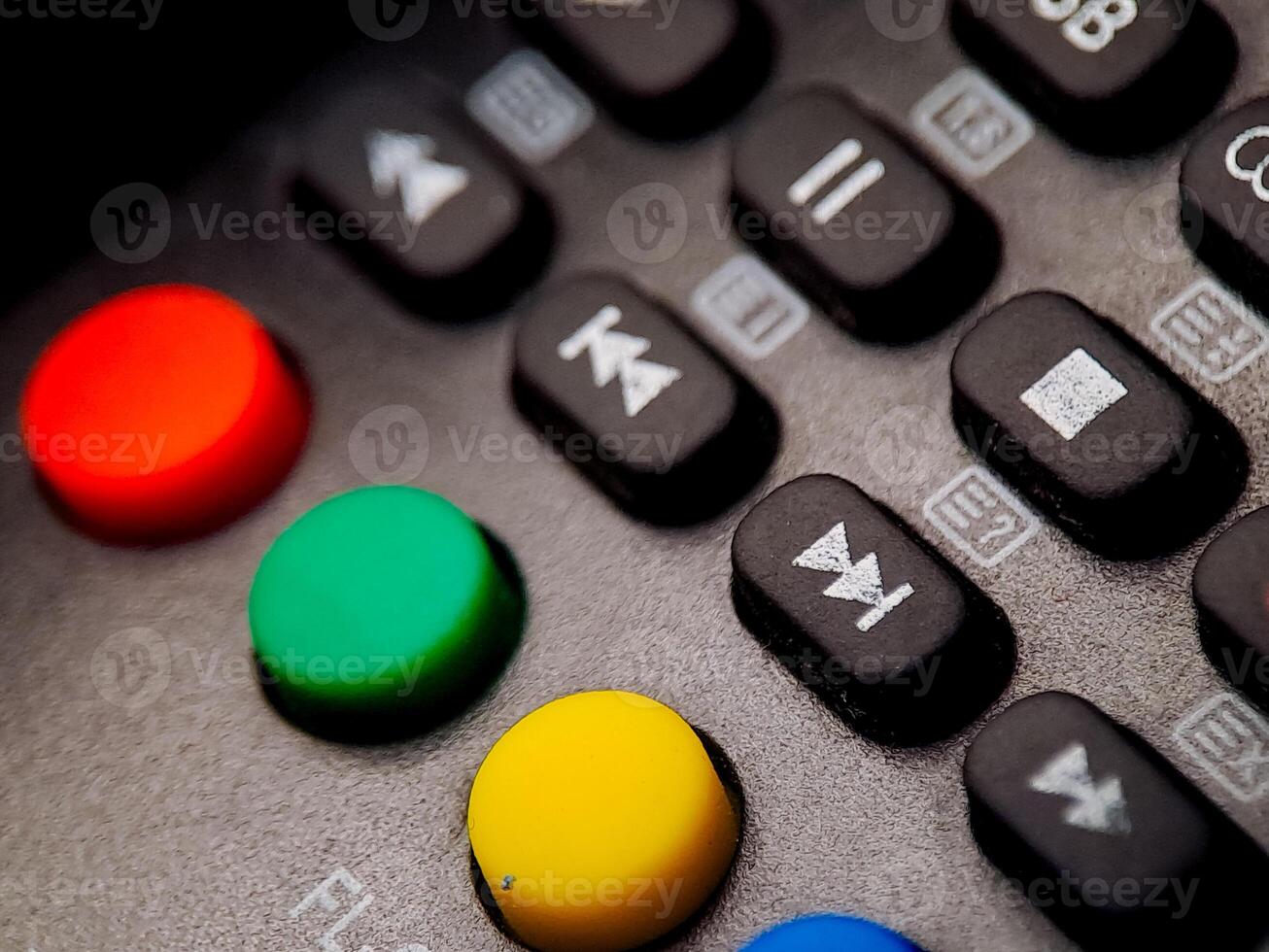 Vibrant macro view reveals colorful buttons and function keys on a dark electronic device panel. photo