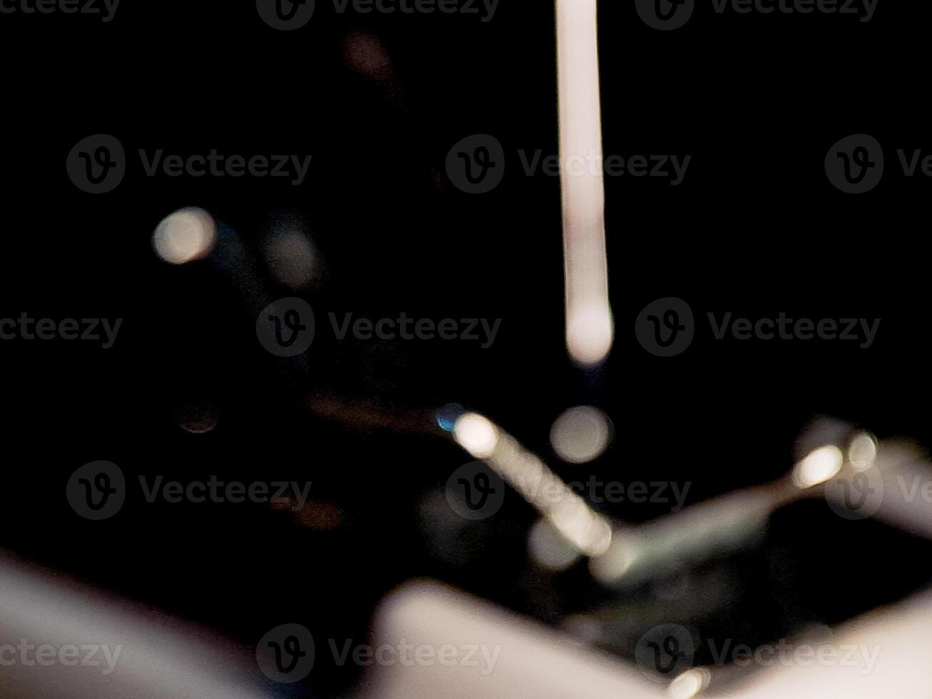 Abstract composition of diffused highlights and shadows creating a dynamic mood with dark tones. photo